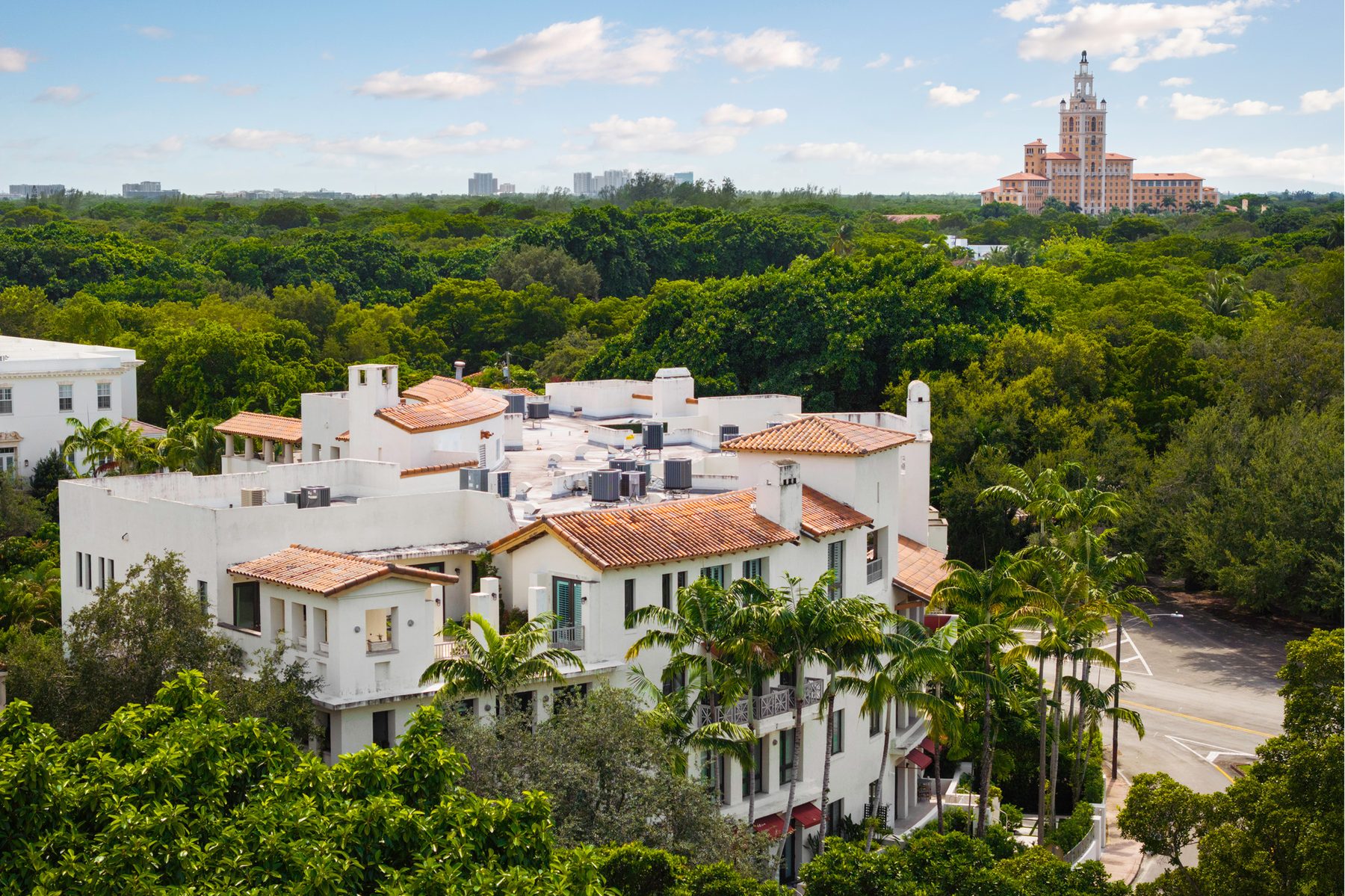 Aerial view of Coral Gables Mediterranean architecture with the Biltmore Hotel in the distance