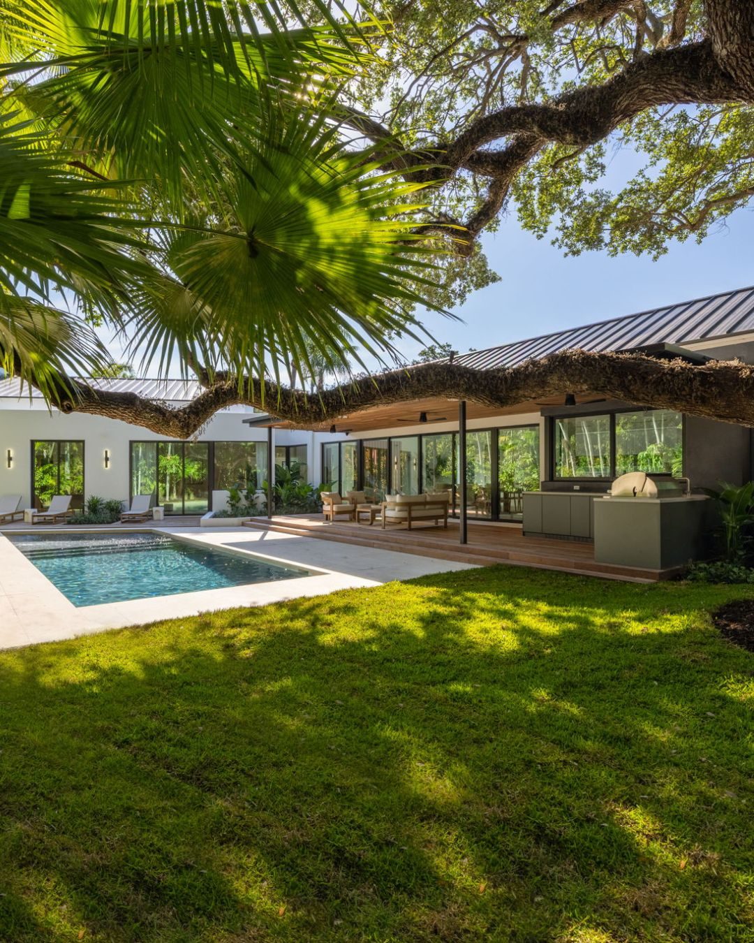 A contemporary Coconut Grove home with pool under the Old Grove oak canopy