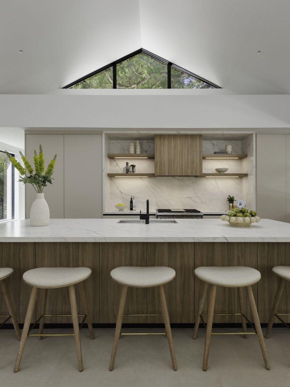 Kitchen with Pedini cabinetry, quartz island and a gable clerestory window over the range wall
