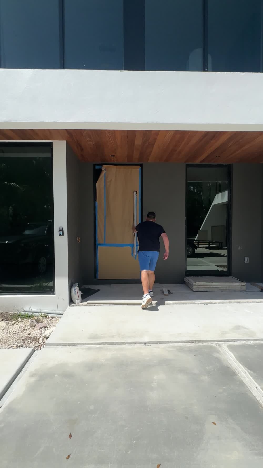 Entry under the wood soffit during final construction