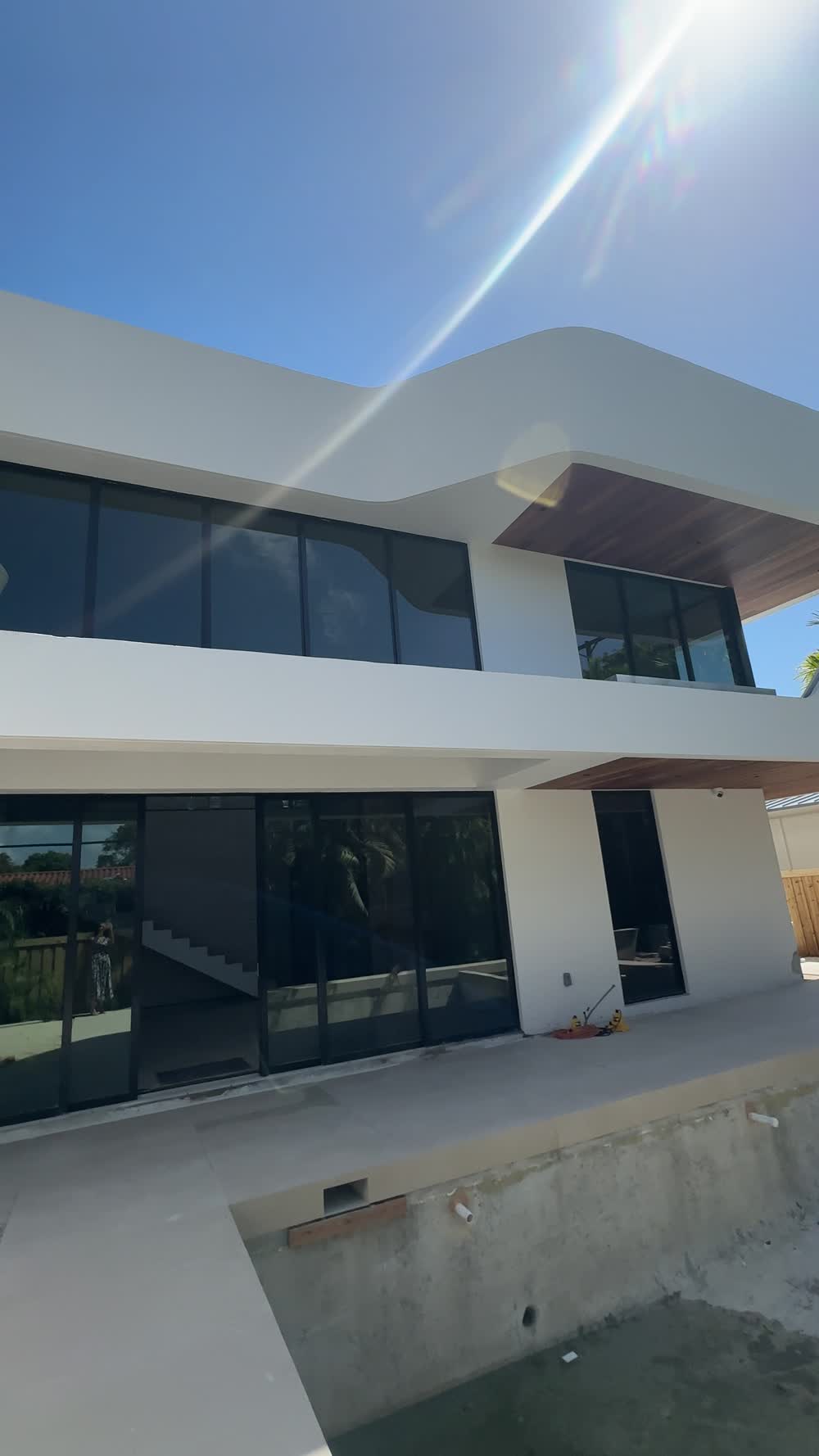 The Wave House exterior — cantilevered roofline over full-height glass