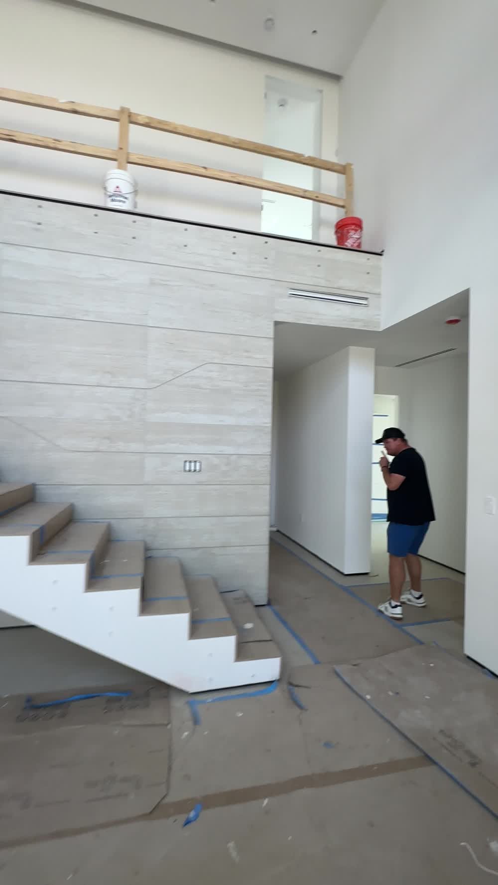 Floating stair against a full-height stone wall